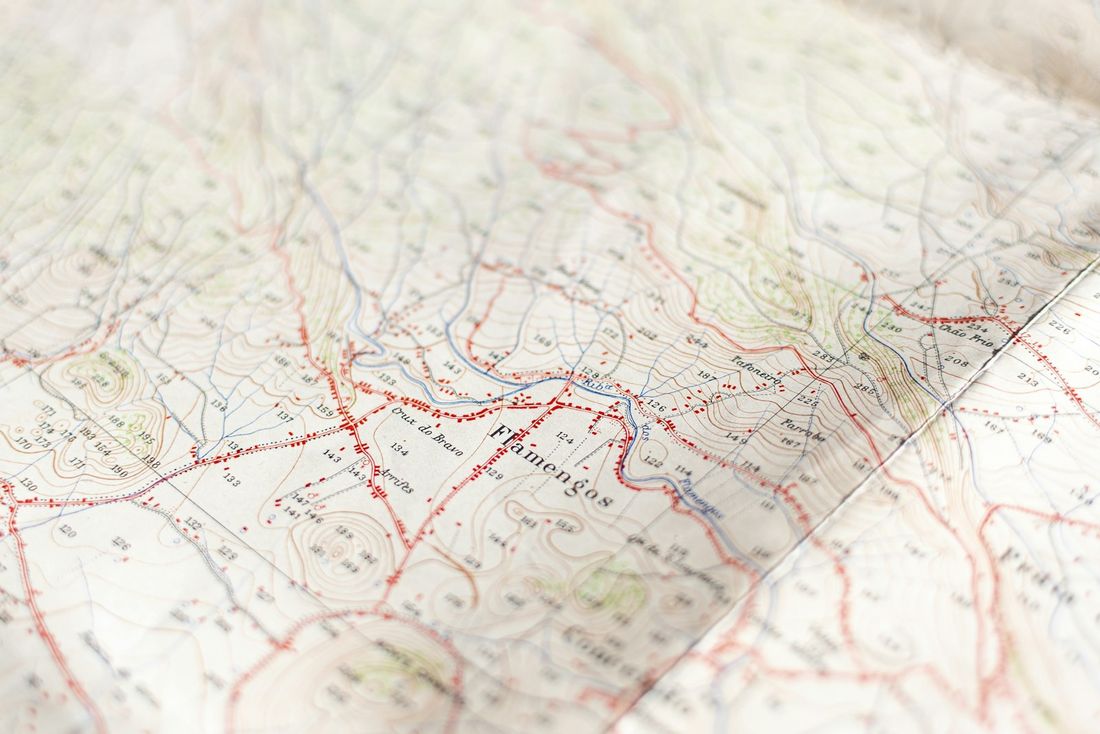 Close-up of a paper map marked with red routes